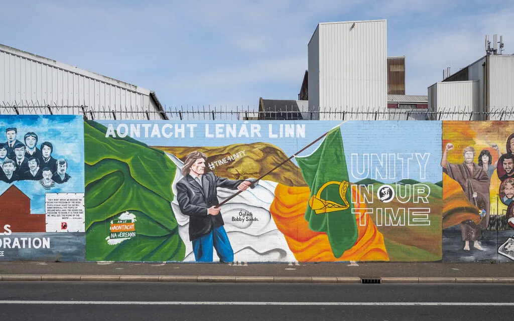 The Falls Road murals — community painters, many unnamed